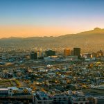 the city of El Paso as the sun rises over the mountains